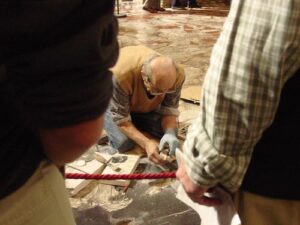 An artisan repairing the floor of the Duomo