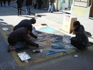 Kids drawing right on the street, for donations
