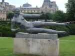 A statue with scratched grafffiti in strategic places