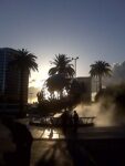 The sun setting through the Universal Pictures logo sculpture