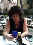 Aviva using her iPhone at dinner