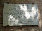 A sign on the wall behind the tomb