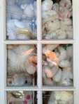 Plush toys through a French door window